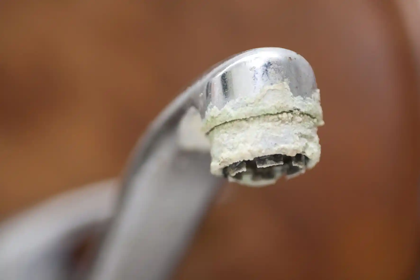 hard-water-scale-buildup-faucet-riverton-utah Hard water mineral scale buildup on a faucet, a common sign a Riverton, Utah home may need water softener service.